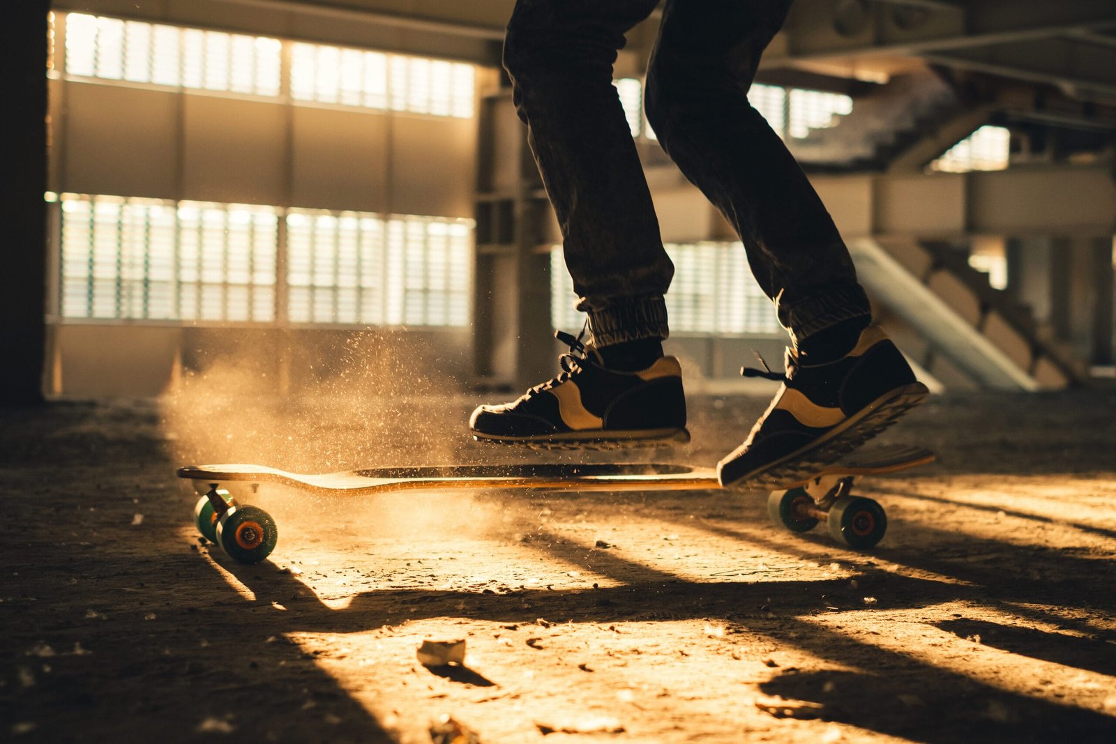 Closeup of legs and sneakers on skateboard