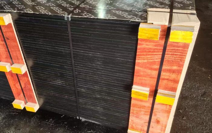 Secure industrial packing of film faced plywood bundles for export